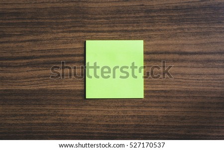 blank sticky note or post it isolated on wood board