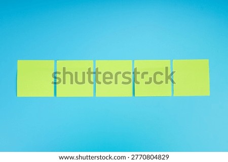 Blank sticky notes arranged in a row on blue background, representing ideas, reminders, planning, brainstorming, organization, and workflow concepts with copy space.