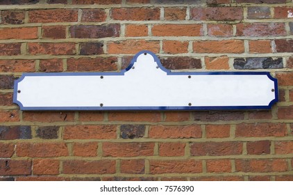 Blank Street Name Sign Fixed To Red Brick Wall. Add Your Own Text. Copyspace.