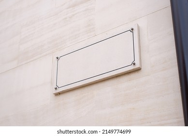 Blank Street Name Sign On A Stone White Facade. Old Town Street