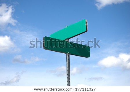 blank street sign against sky and clouds