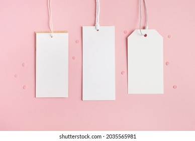 Blank tag cards on pastel pink background. Sale, discounts and shopping concept. Top view, flat lay, copy space, mockup