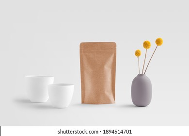 Blank tea bag packaging, teacups, bag, flowers, on a white background, packaging mockup with empty space to display your branding design.