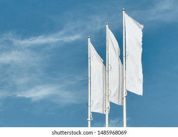 Blank three white flags in the sky. Branding mockup. 