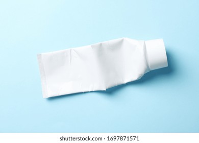 Blank Toothpaste Tube On Blue Background, Space For Text