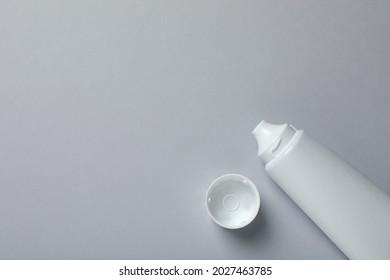 Blank Tube Of Toothpaste On Light Grey Background, Top View. Space For Text