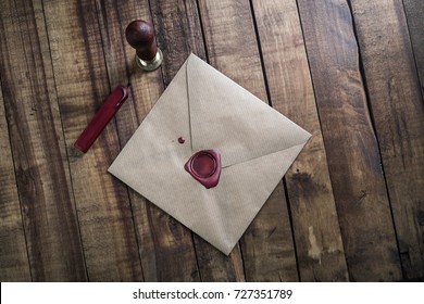 Blank Vintage Envelope, Sealing Wax And Stamp On Wood Table Background. Responsive Design Mock Up. Postal Stationery. Top View.