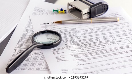 Blank W4 Tax Form, Magnifying Glass And A Pen On Table, Tax Season, Business Concept