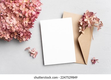 Blank wedding invitation card mockup with envelope and dry hydrangea flowers. Flat lay, top view, copy space - Shutterstock ID 2247529849