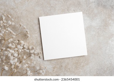 Blank wedding invitation, flyer or greeting card mockup on trendy beige background, white card mock up with copy space