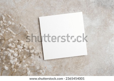 Blank wedding invitation, flyer or greeting card mockup on trendy beige background, white card mock up with copy space