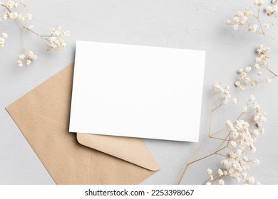 Blank wedding invitation or greeting card mockup with envelope, flat lay, copy space