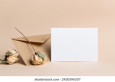 Blank wedding invitation or greeting card mockup with envelope and dry flowers