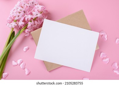Blank wedding invitation stationery card mockup with envelope on pink background with hyacinth flowers and pink hearts, feminine blog. Valentines day card, valentines day background, mothers day