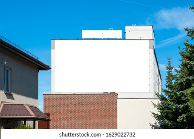 Blank White Advertising Banner On The Wall Of The Building