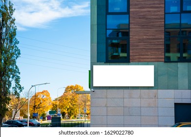 Blank white advertising banner on the wall of modern building