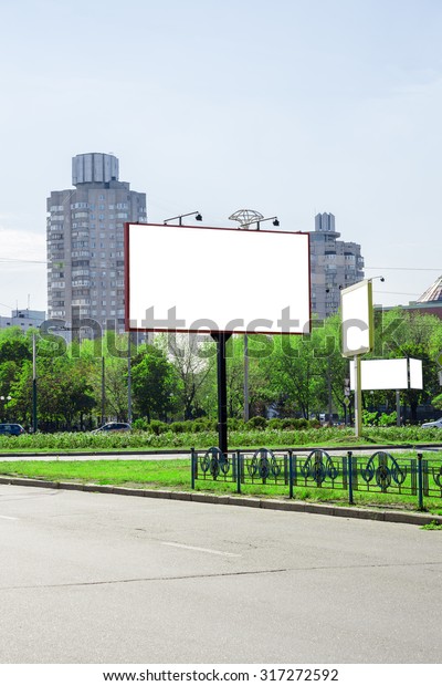 Blank white advertising banners near the\
road in summer. Put your text or images\
inside