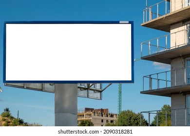 Blank white advertising billboard near modern apartment buidling and construction site in the city - Shutterstock ID 2090318281