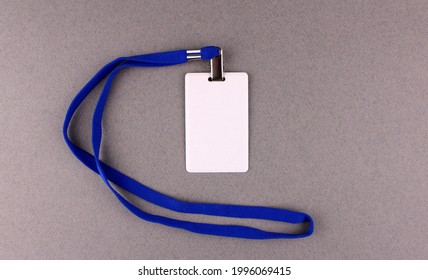 Blank White Badge With Blue Drawstring On Gray Background. Pass To Work, Conference