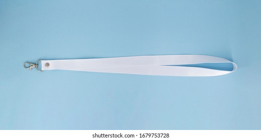 Blank white Bagde Lanyard lace mockup. Plain empty cotton band mock up isolated on blue background.