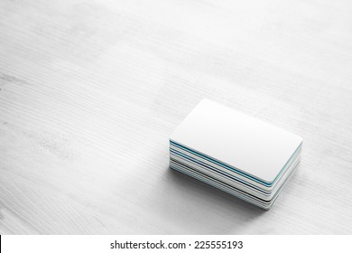 Blank White Bank Card & Pile Of Credit Cards And Bank Cards On White Wood