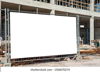 Blank White Banner For Advertisement Mounted On The Fence Of Construction Site On A Sunny Day.