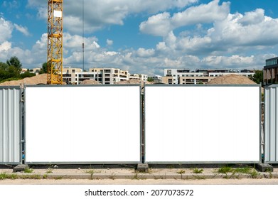 Blank white banner for advertisement mounted on the hoardin of construction site - Shutterstock ID 2077073572