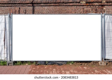 Blank white banner for advertisement mounted on the hoarding of construction site in front of old brick building - Shutterstock ID 2083483813