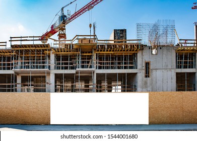 Blank white banner for advertisement on a fence of a building under construction