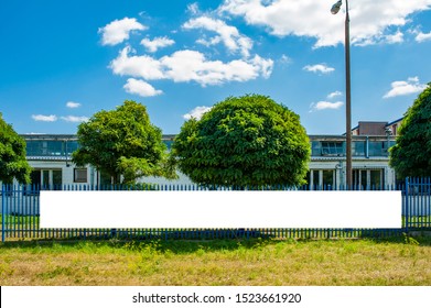 Blank White Banner Mockup Mounted On The Fence Of Industrial Building