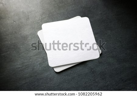 Blank white beer coaster stack mockup, top view, lying on the textured background. Squared clear can mat design mock up isolated. Quadrate cup rug display