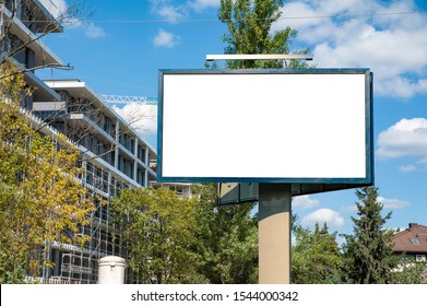 Blank white billboard mockup in front of the modern building under construction - Shutterstock ID 1544000342