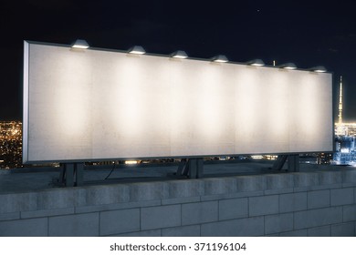 Blank White Billboard On The Top Of Building At Night City Background, Mock Up