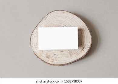 Blank White Business Card Mockup On Wooden Plate, Chop Board. Grey Table Backgound. Modern Minimalist Template. Branding Identity. Natural Winter Design. Flat Lay, Top View. 