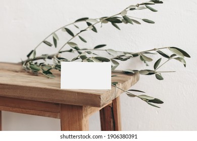 Blank White Business Card Mockup And Olive Tree Branch On Old Wooden Bench, Table Background. Elegant Modern Template For Branding Identity. Mediterranean Summer Design. Wedding Stationery. 