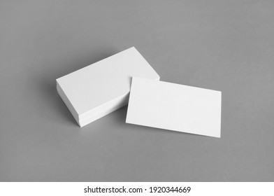 Blank white business cards on gray paper background. Mockup for branding identity. Template for graphic designers portfolios. - Shutterstock ID 1920344669