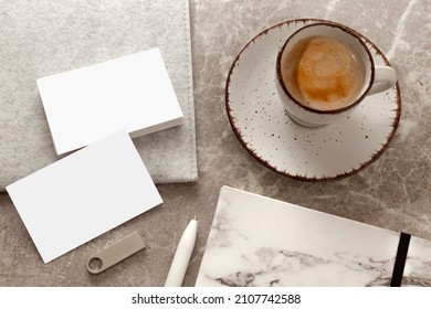 Blank white business cards on table, with blank USB stick, cup of coffee. Mockup for branding identity. Possibility to show both sides of card. Template for graphic designers. Free space, copy space.
