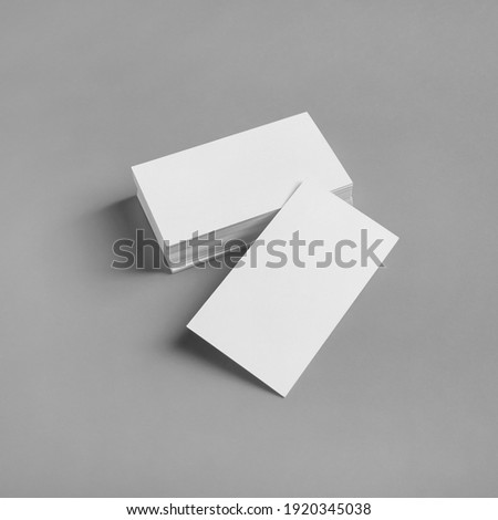 Blank white business cards on gray paper background. Mockup for ID. Template for graphic designers portfolios.