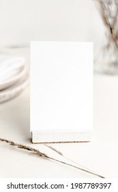 Blank White Card As A Table Number Sign Mockup With Minimal Accessories And Beige Neutral Colors. Earthy Minimalist And Modern Seating Card Mockup For Wedding Stationery And Events. 