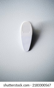 Blank White Chip Clip Magnet On A White Ripple Textured Refrigerator Surface Background. Space For Text And Logos. Promotional Product.