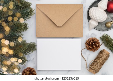 Blank white christmas card composition. Fir branch, festive seasonal decorations, lay flat background template