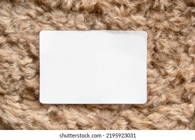 Blank White Clothing Label On Beige Faux Fur Background Closeup