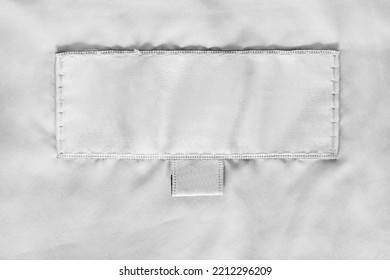 Blank White Clothing Label Stitched On White Fabric Closeup