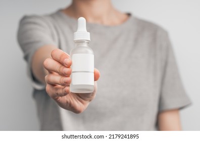 Blank White Cosmetic Tube Isolated On White Background. Female Hand With Applied Cream Touches Cosmetic Tube. Concept Of Cream, Hand Lotion. Winter Skin Care. Woman Using Hand Cream From A Tube.