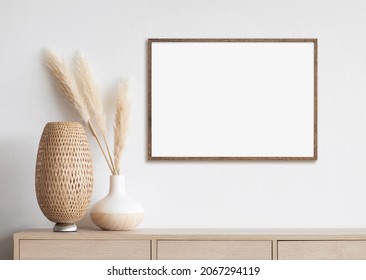 Blank white empty picture frame mockup on white wall. Artwork in interior design. Modern boho style interior with poster template - Shutterstock ID 2067294119