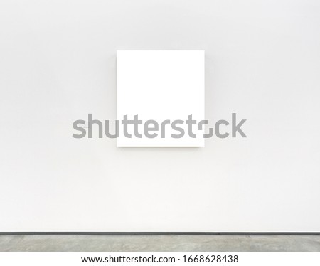 Blank white frame on wall with caption