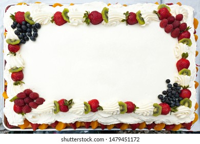 Blank white frosted cake with a fruit border and copyspace. - Shutterstock ID 1479451172