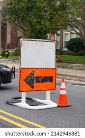 Blank White Information Road Sign On Top Of An Orange Detour Sign With A Black Arrow