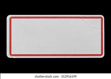 Blank White Label Adhesive with Red Border isolated on Black Background. Sticker or Paper Tag with Wrinkles and Scratches. Close Up. Top View with Copy Space for Text or Image