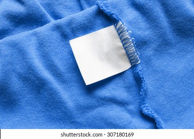 Blank White Label On Blue Cloth As A Background